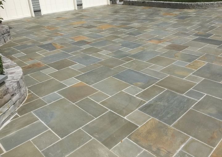 Natural flagstone patio with a curved stone wall